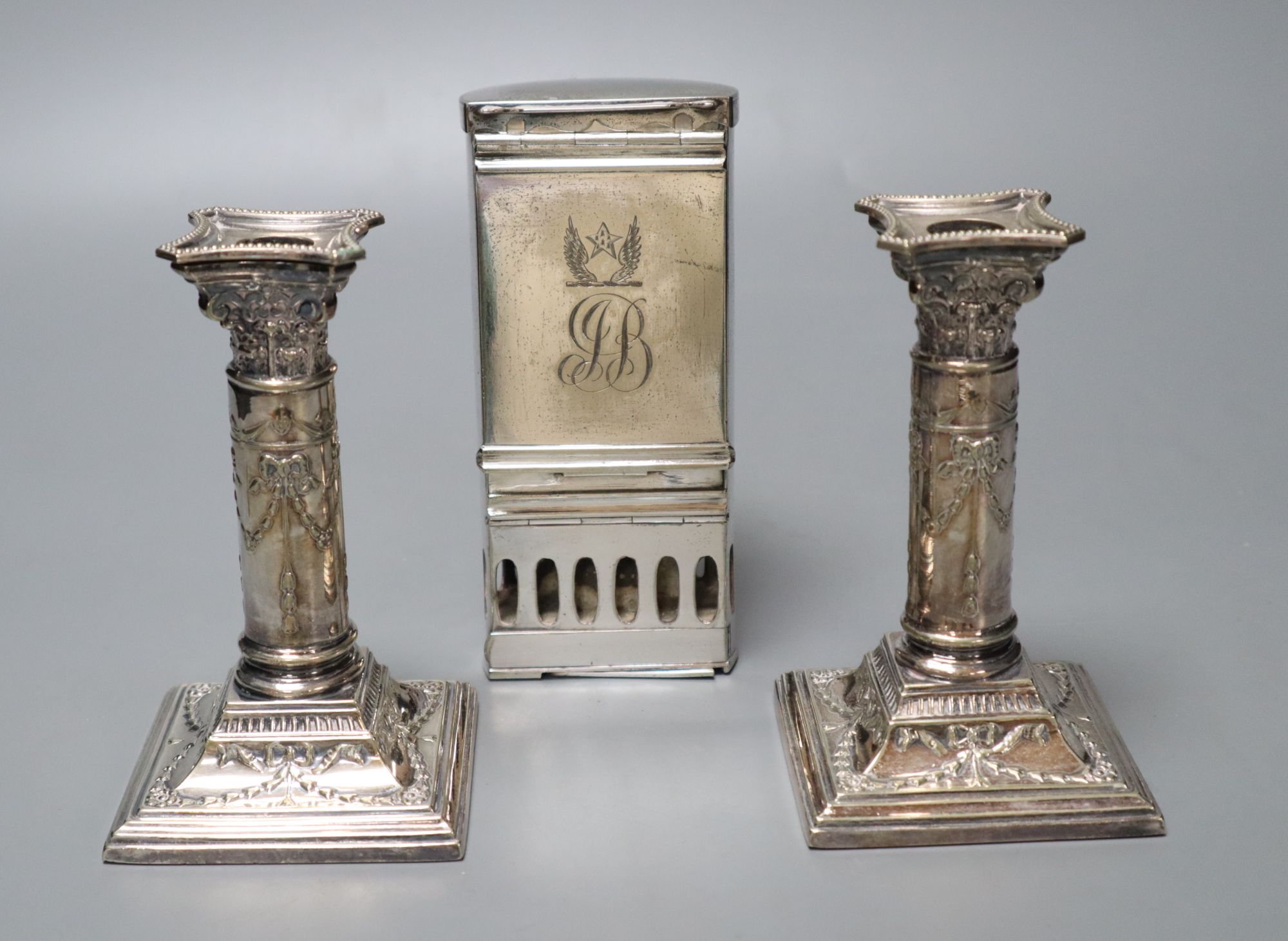 A pair of Victorian plated and embossed dwarf candlesticks and a Victorian plated pocket lamp, height 24cm (3)
